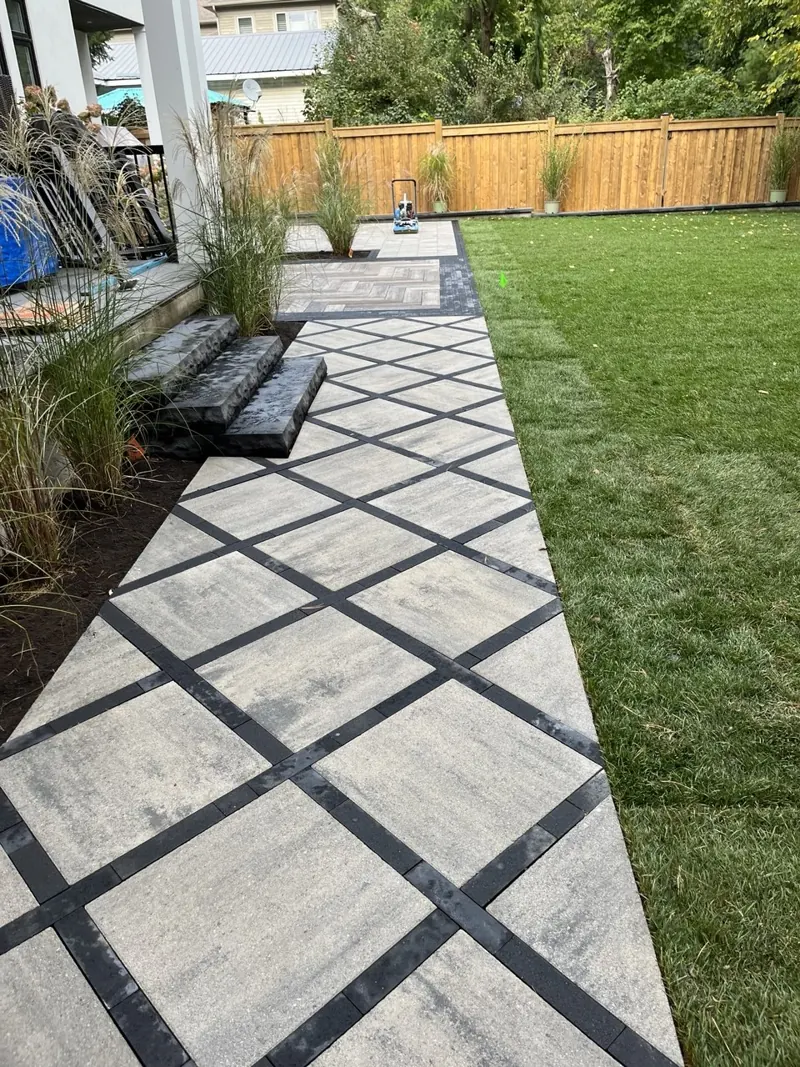 Diamond-pattern walkway beside newly laid sod