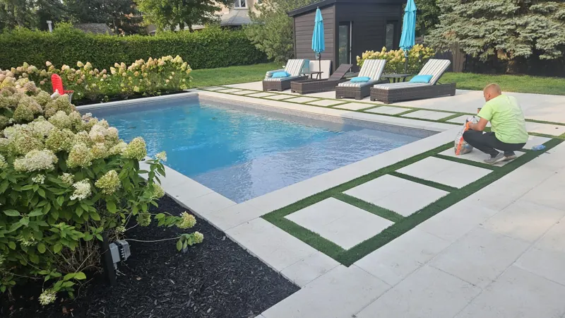 Light pool deck with turf joints and a hydrangea bed