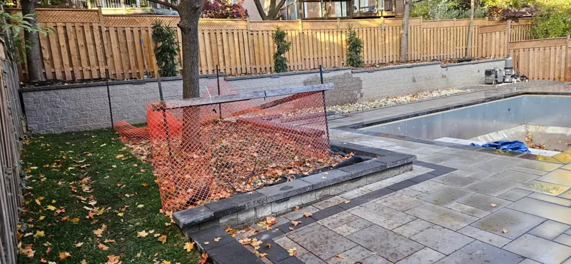 Interlock pool surround with a border course, mid-build
